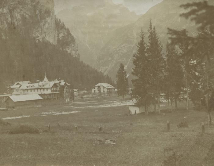 [Photograph of buildings with mountains in background]