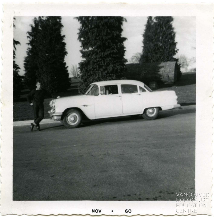 [Photograph of Frank Orban near a car]


