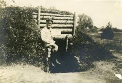 [Alfred Meyer sitting alone in the field while serving in the army]